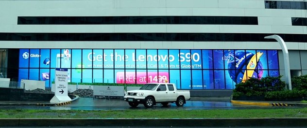 a car parked in front of an led screen